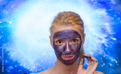 Blonde model wearing a galaxy, sparkle peel off mask