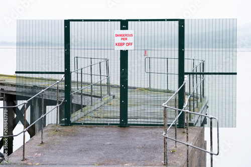 Dangerous pier keep off sign on abandoned sea jetty