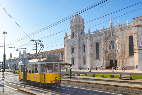 Obraz na płótnie historic classic yellow tram of Lisbon built partially of wood in front of famous Jeronimos monastery, Portugal w salonie