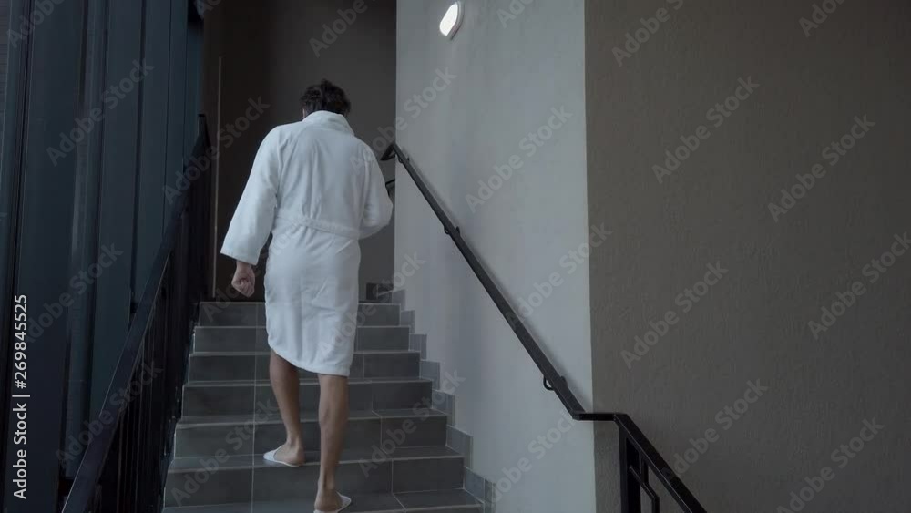 Man in slippers climbs the stairs