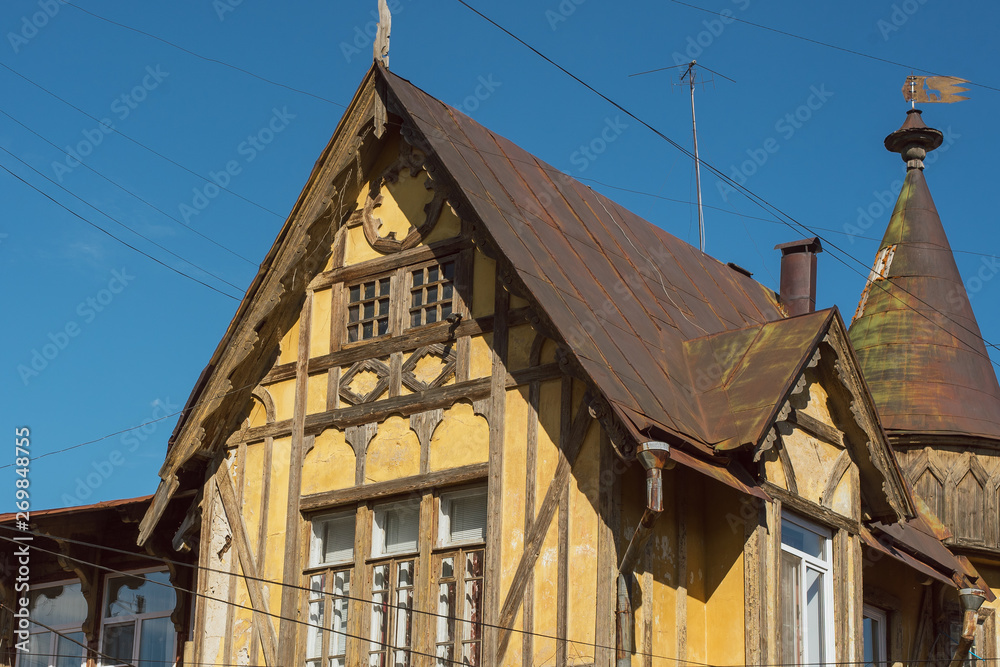 Old German wooden yellow building. Upper part of the building.