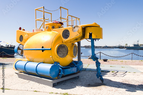 Small yellow rescue bathyscaphe with illuminators and mechanical manipulators photo