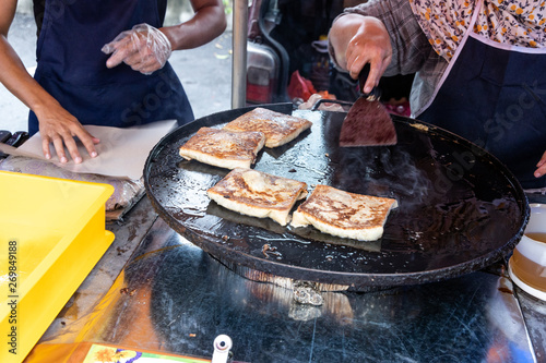 Seller preparing murtabak at street stall for iftar during Ramadan. photo
