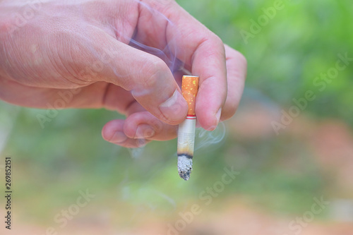 man hand holding a cigarette for smoking close up