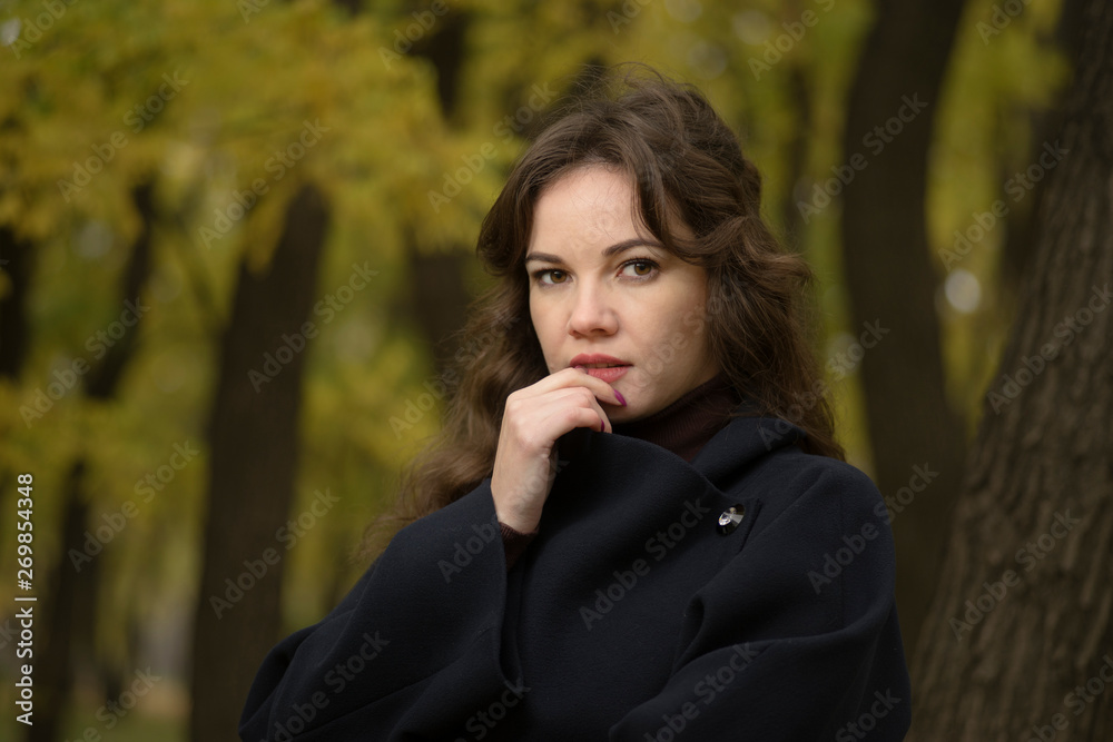 portrait of thoughtful young woman in autumn park portrait of thoughtful young woman in autumn park