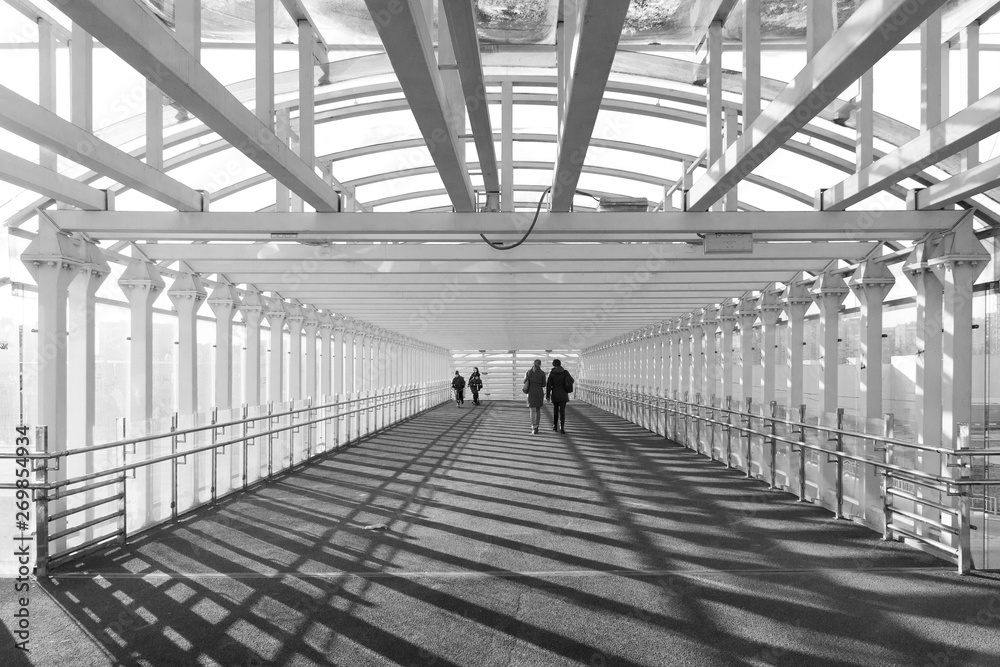 Silhouettes of people in a tunnel in black and white Silhouettes of people in a tunnel in black and white