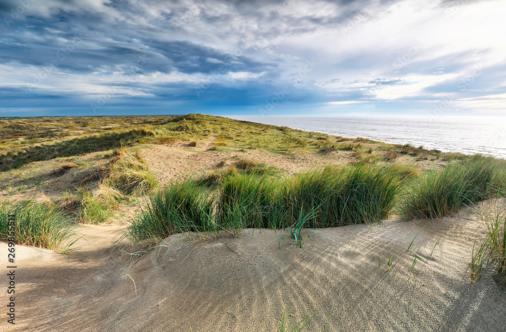 sunshine over sand dune by North sea