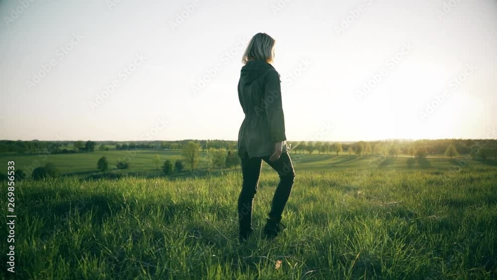 Young Woman Walking on Mountain Trail. Slow motion steadicam footage. Amazing sunset. Nature landscape. Young Woman Walking on Mountain Trail. Slow motion steadicam footage. Amazing sunset. Nature landscape.
