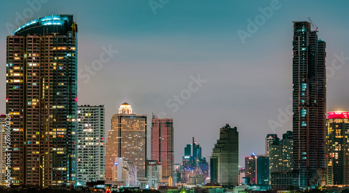 Cityscape of modern building in the night. Modern architecture office building. Skyscraper with beautiful evening sky. Business and financial center building. Condo in the city with night light. © Artinun