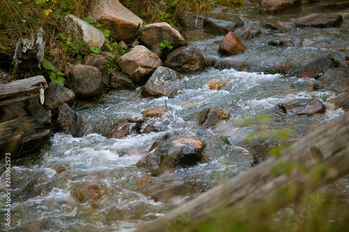 The mountain river flows through a rocky surface.