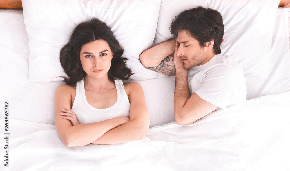 Young couple in bed having problems and crisis Young couple in bed having problems and crisis