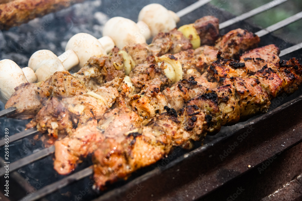 grilled meat and mushrooms on the grill. barbecue close up