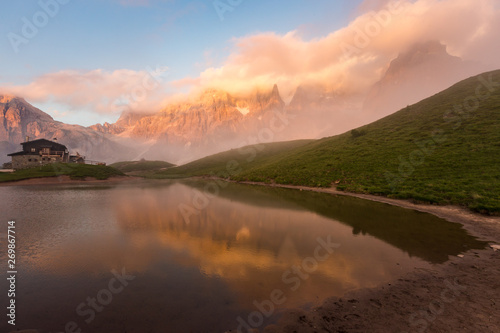 Sunset in Passo Rolle - Baita Segantini lake in Dolomite mountain range, Italy.