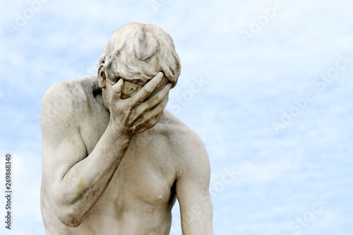 Facepalm - ashamed, sad, depressed. Statue with head in hand