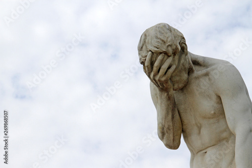 Facepalm - ashamed, sad, depressed. Statue with head in hand