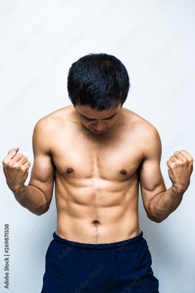Smart and strong asian muscle man posting on white background