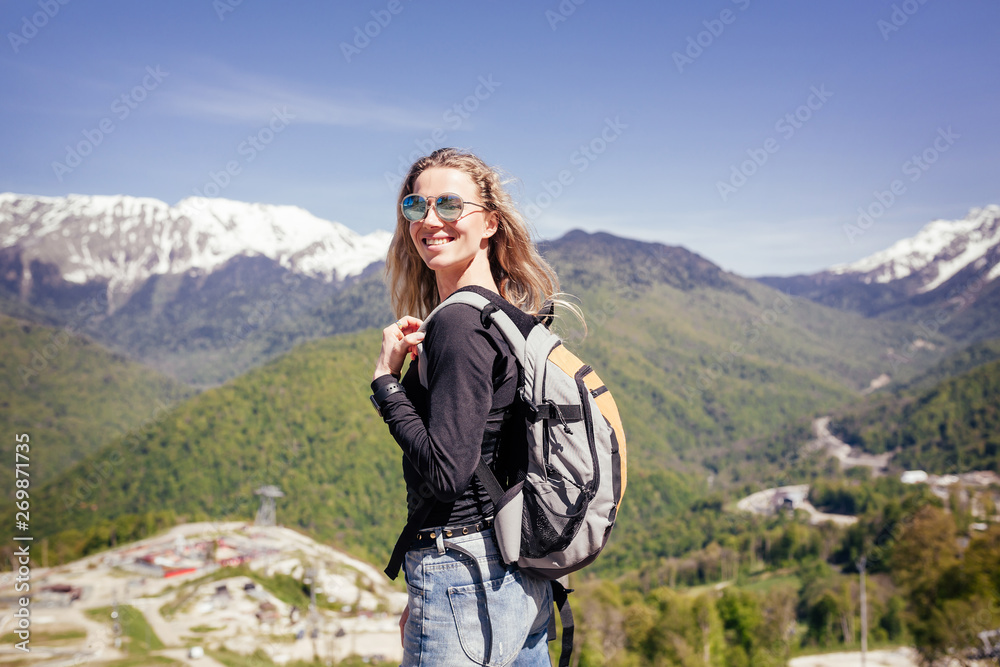Portrait of a beautiful young girl lover and protector of the environment and trekking goes to picturesque places in the mountains. Concept of goal achievement and active vacation