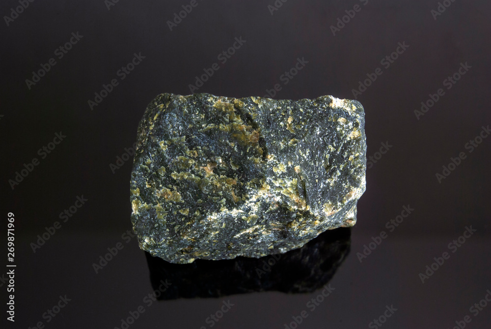 Serpentine is a natural mineral. On a black background. Origin: Russia, Ural. Serpentine is a natural mineral. On a black background. Origin: Russia, Ural.