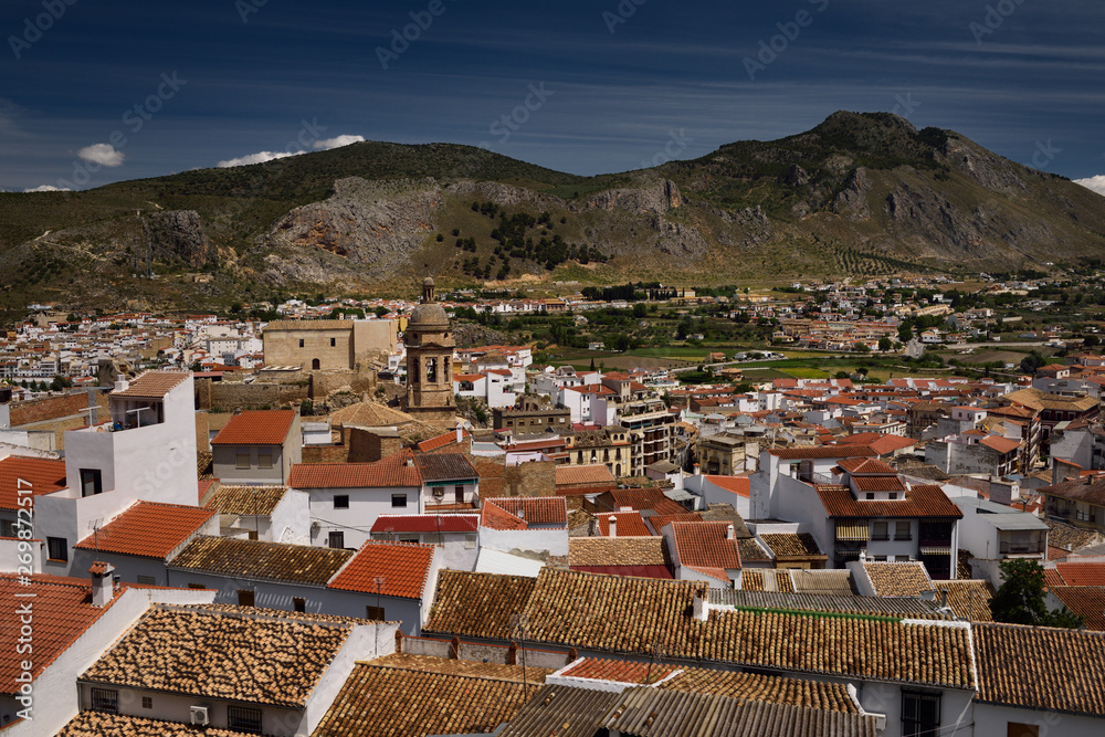 Rooftop tiles with Church of the Incarnation and Gorda Peak at Loja Granada Spain