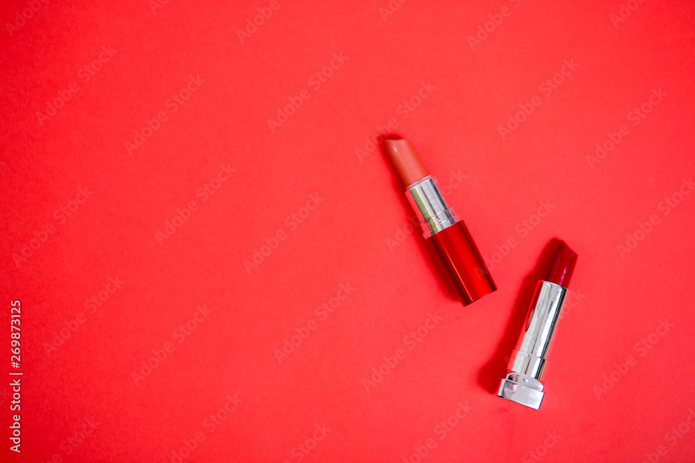 Lipstick isolated on red background