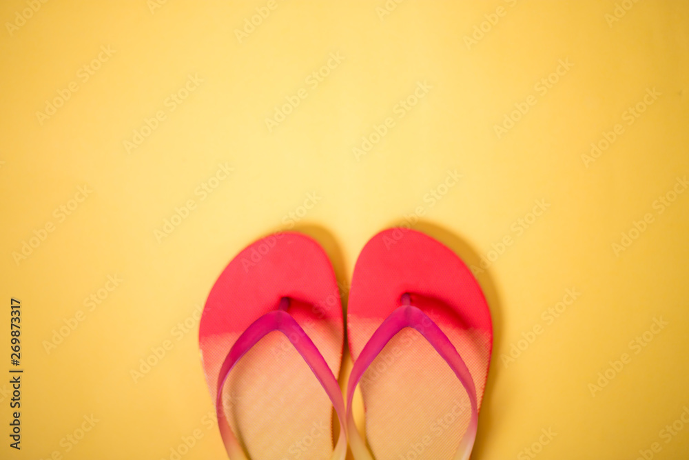 Beach flip flop on yellow background Beach flip flop on yellow background