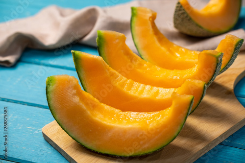 Sliced ripe melon on wooden table