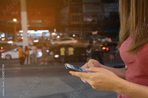 Woman use mobile phone, night in the city, technology concept