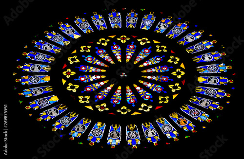 Round stained glass window inside catholic church.