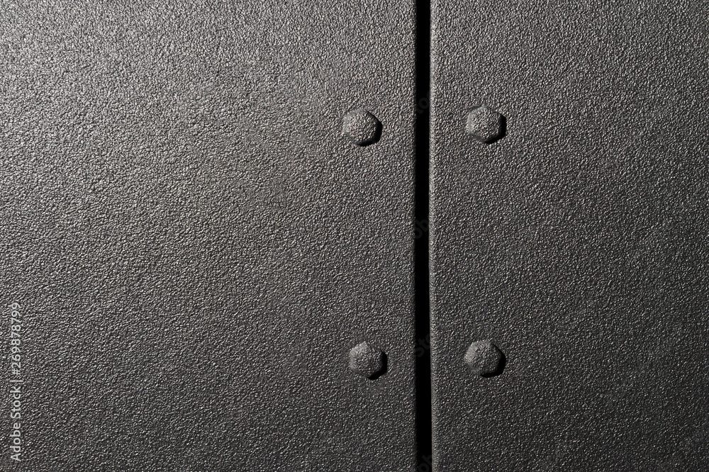Surface of powerful suv bodywork, side part of car with bolts and black textured paint coating, detail of vehicle 