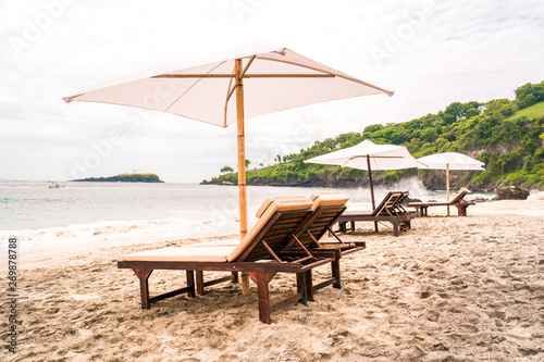 Empty sunbeds waiting for tourists on Virgin beach or Pasir Putih or Perasi Beach on Bali  Indonesia. Beautiful and clean tropical white sand beach