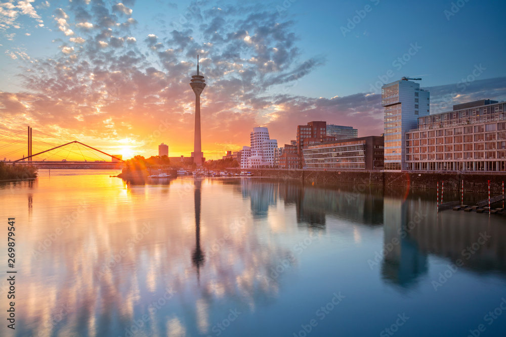 Dusseldorf, Germany. Cityscape image of Düsseldorf, Germany with the Media Harbour and reflection of the city in the Rhine river, during sunrise. - obrazy, fototapety, plakaty 