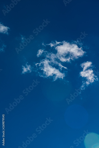 Wispy Cloud Alone on Vibrant  Deep Blue Sky
