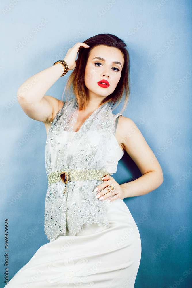young pretty woman with blond hair on blue background, sensual makeup, fashion sexy look, golden jewelry, lifestyle people concept close up young pretty woman with blond hair on blue background, sensual makeup, fashion sexy look, golden jewelry, lifestyle people concept close up