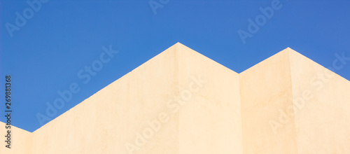 geometry shapes lines and corners concept pattern picture architecture design of common building wall in some of south countries, vivid blue sky background, copy space
