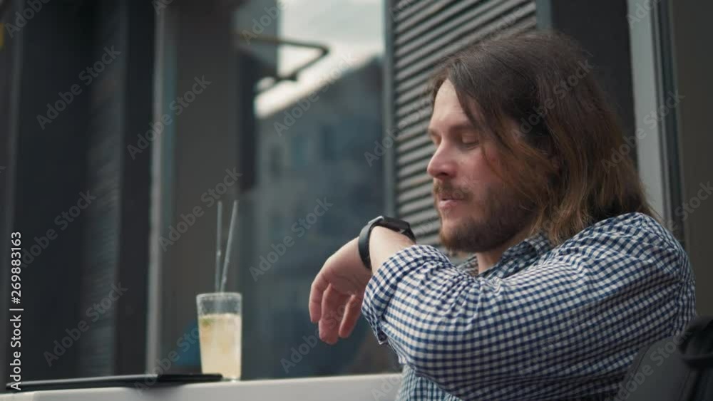 Man with smartwatch using voice recorder recognition audio message command outside on street. Deadline, technology and people concept - creative man with smartwatch using voice command recorder