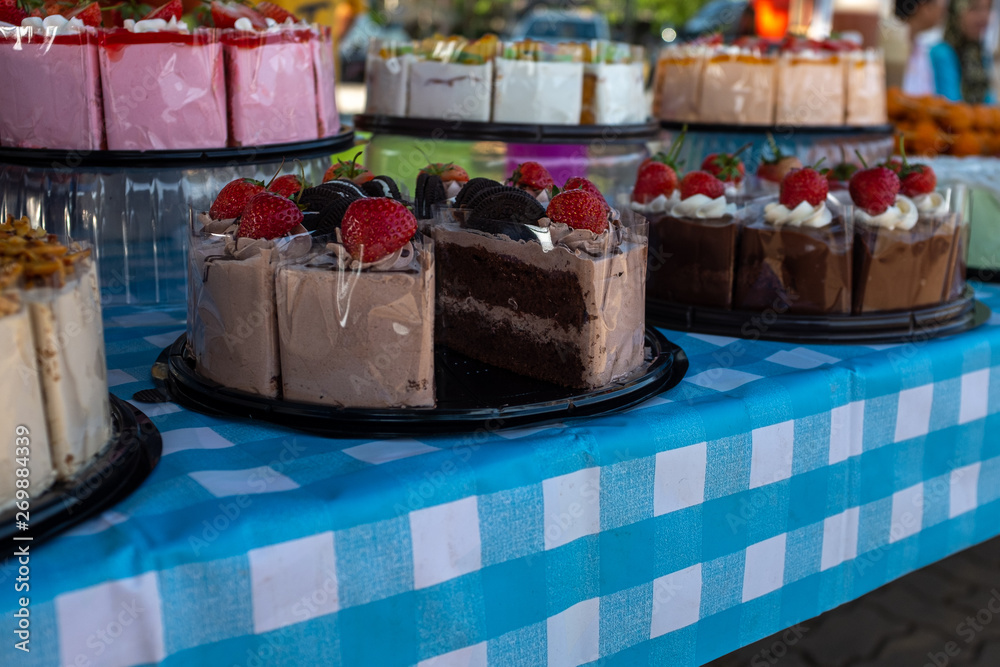Homemade yummy looking cakes for sale at a Farmers Market, the foreground being chocolate, nobody in the image