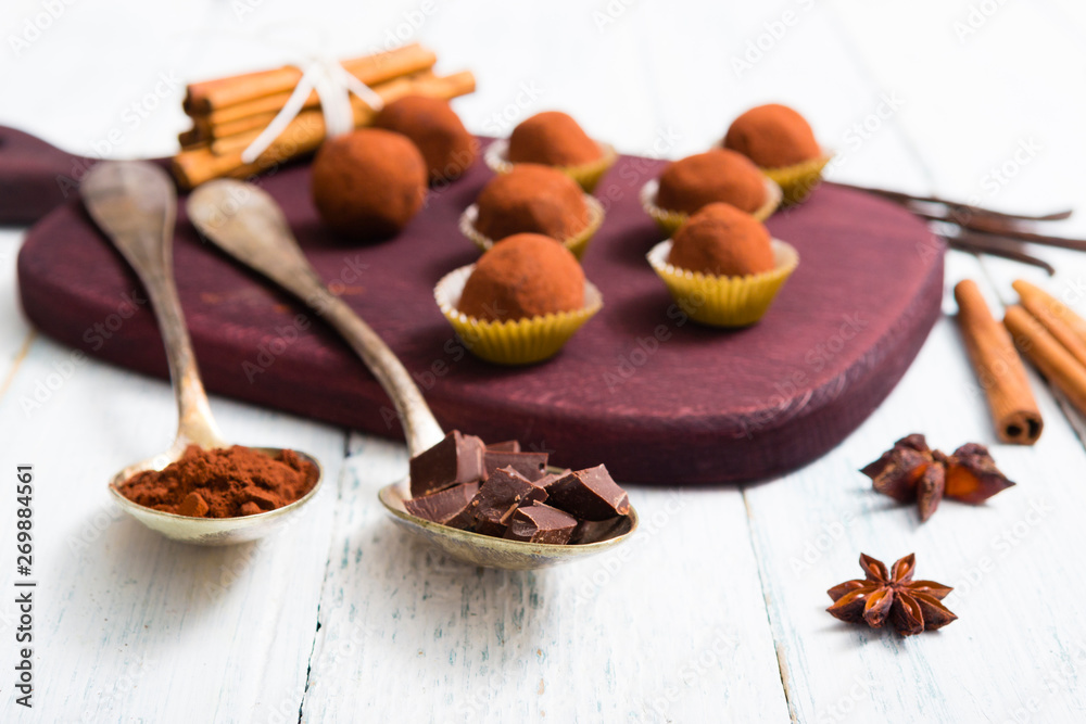 chocolate truffles, cocoa powder, broken dark chocolate on white wooden chocolate truffles, cocoa powder, broken dark chocolate on white wooden