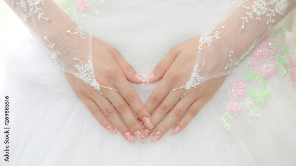 bride holding hands on the dress. beauty and fashion in women's clothing. bride holding hands on the dress. beauty and fashion in women's clothing.