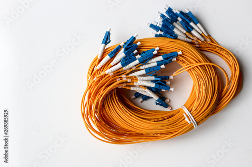 Wallpaper Mural Yellow optical fiber network cable with blue connectors isolated on white background Torontodigital.ca