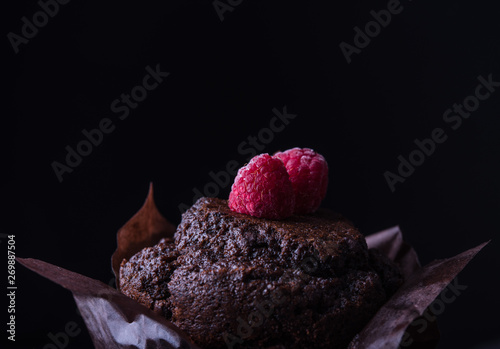  chocolate muffin with raspberry darkphoto photo