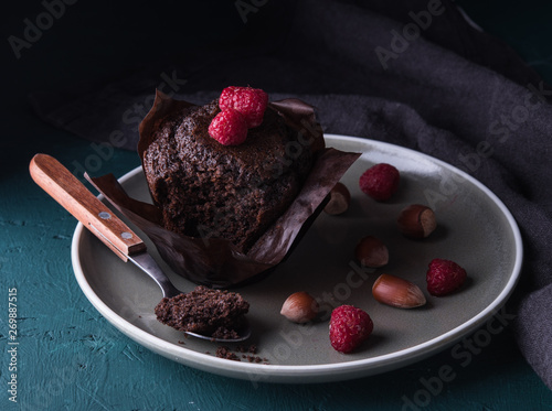  chocolate muffin with raspberry darkphoto photo