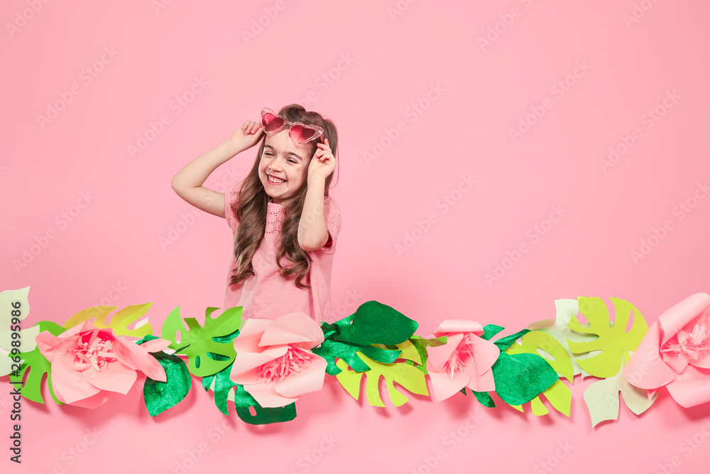 Portrait of a little girl with sunglasses on a pink background Portrait of a little girl with sunglasses on a pink background