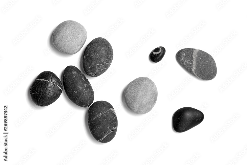 Scattered sea pebbles. Smooth gray and black stones isolated on white background. Top view Scattered sea pebbles. Smooth gray and black stones isolated on white background. Top view