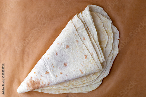 Thin pita bread on baking paper. Armenian pita bread close-up.