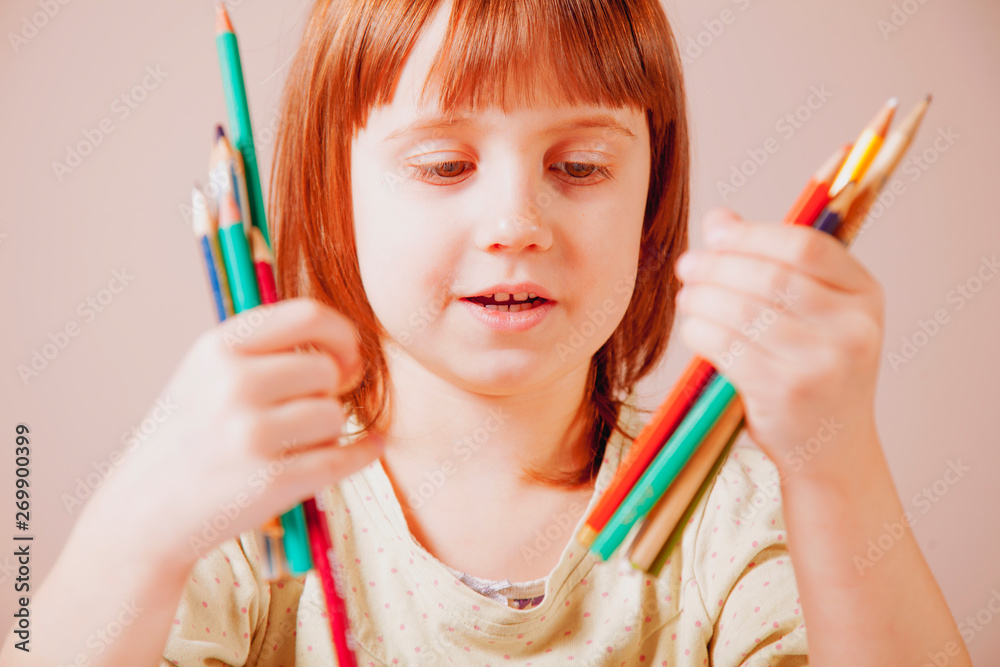 Artistic development concept. Portrait of cute little child girl with colored pencils. Artistic development concept. Portrait of cute little child girl with colored pencils.