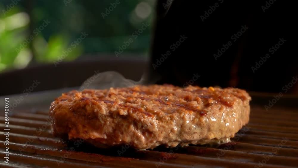 Close-up camera movement near tasty beef burger fry on the hot grill Close-up camera movement near tasty beef burger fry on the hot grill