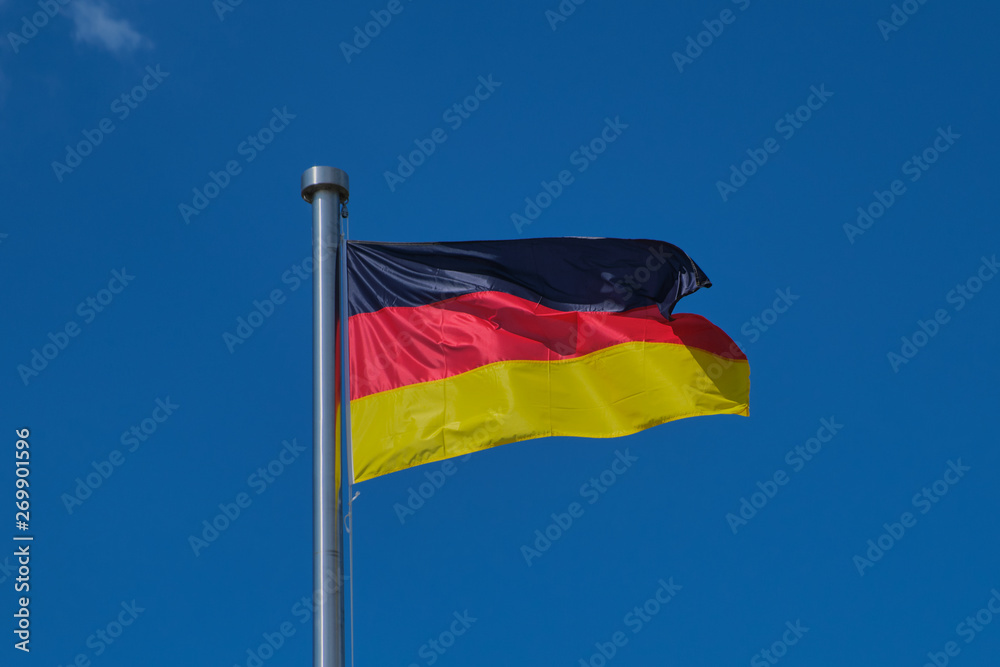photograpy of a waving flag of Germany against blue cloudless sky photograpy of a waving flag of Germany against blue cloudless sky
