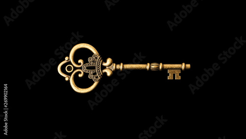 Old bronze key on a black background