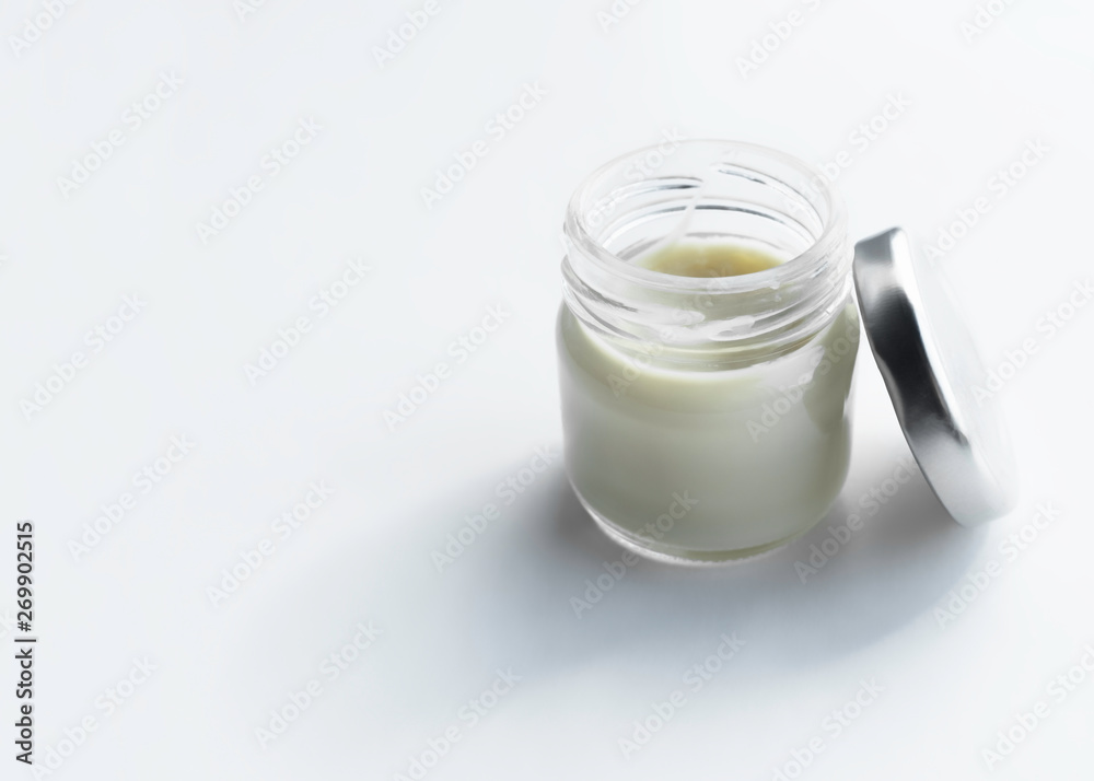 glass jar with cosmetic cream on a light background. copy space glass jar with cosmetic cream on a light background. copy space