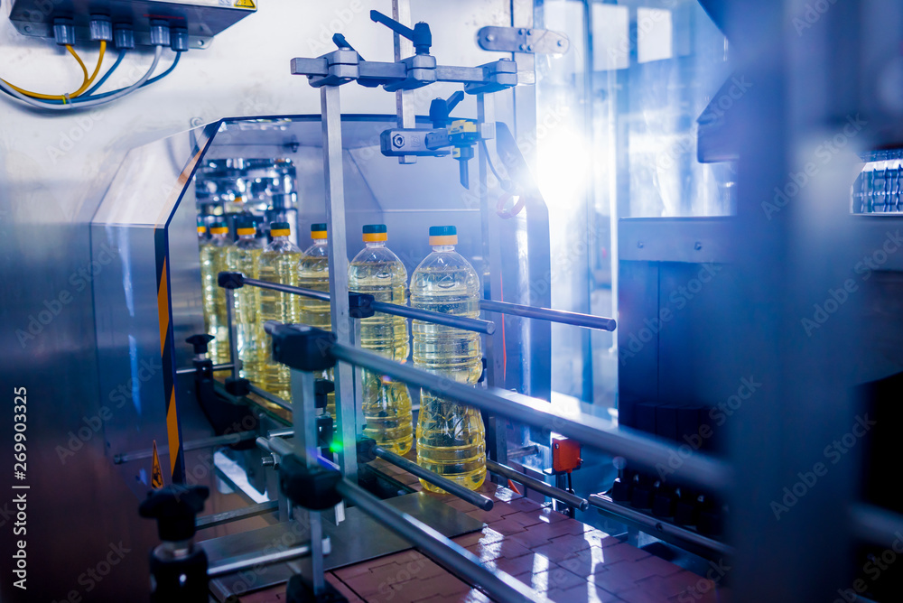 Bottling line of sunflower oil in bottles. Vegetable oil production plant. High technology. Bottling line of sunflower oil in bottles. Vegetable oil production plant. High technology.